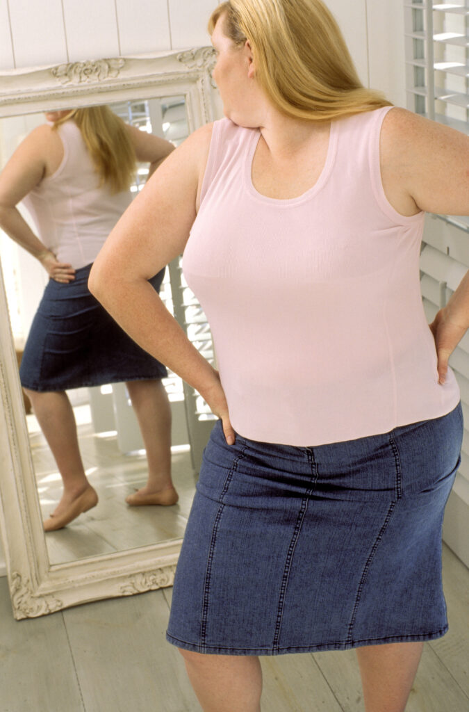 Woman looking at herself in the mirror