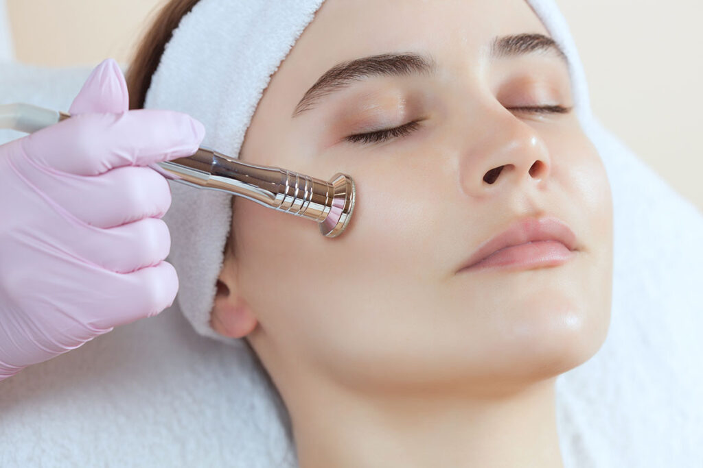 Woman having a microdermabrasion treatment applied on her face.