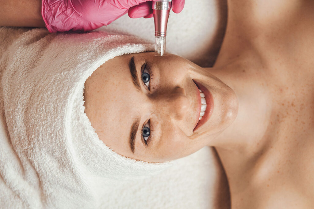 A young woman receiving a microdermabrasion treatment to treat her skin conditions.